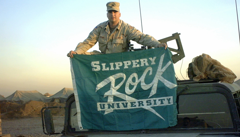 Robert Snyder, SRU professor of elementary education and a 1992 graduate, shows his colors while deployed as an Army officer in Iraq. Snyder served there in 2003-2004.