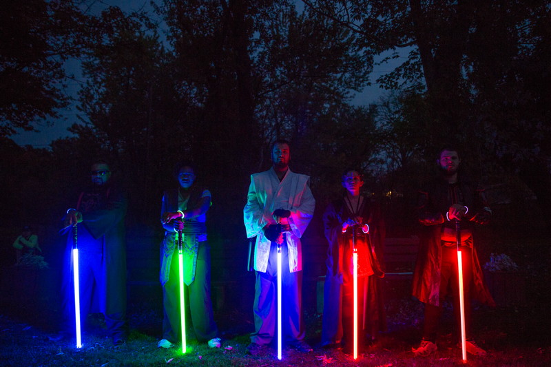 Students cosplaying with light swords