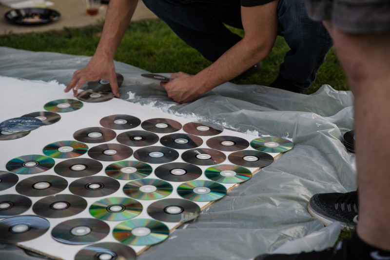 people making board with cd's