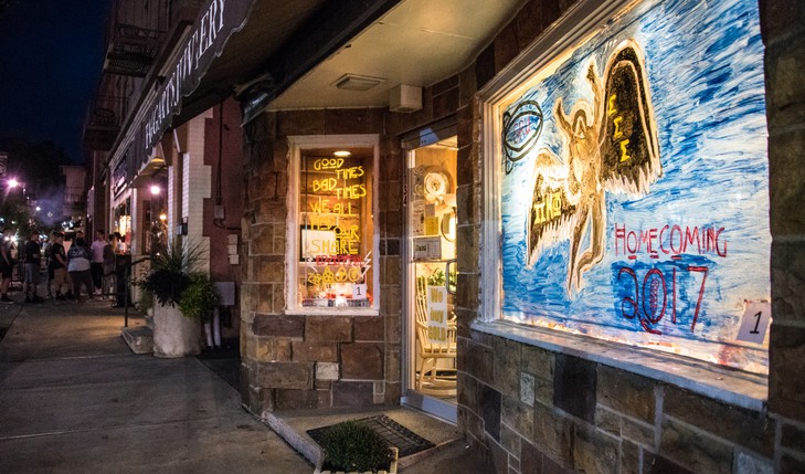 Art painted on windows of local business at night