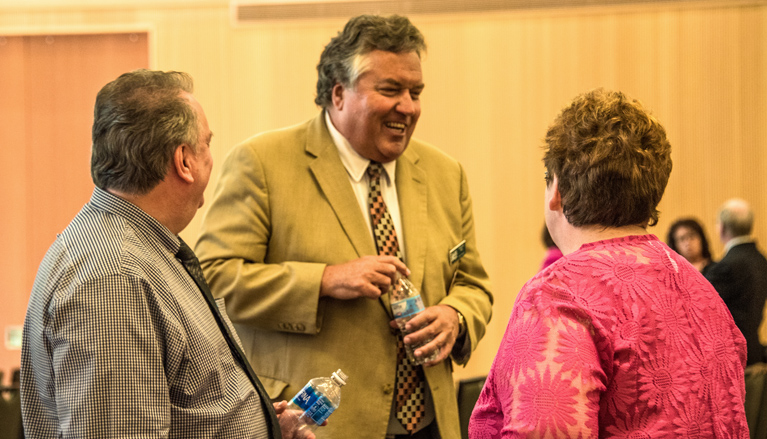 SRU Interim President Philip Way shares a laugh with staff following the State of the University Address Sept. 7.