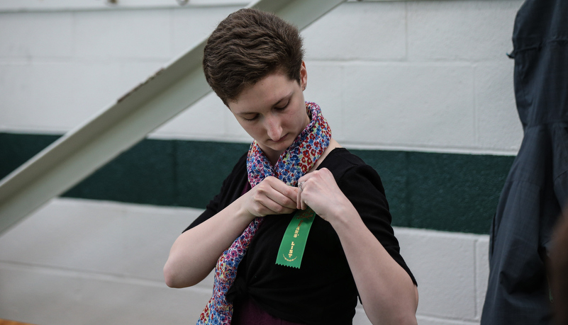 Student putting on a ribbon