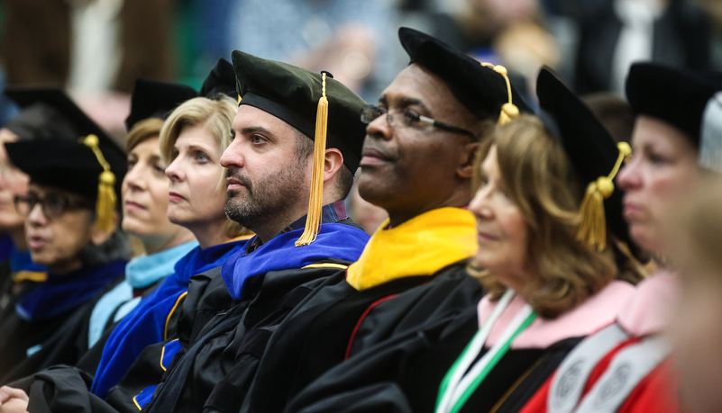 Professors listen to a speach