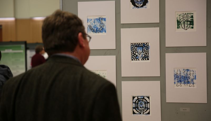 Man examining art exhibit