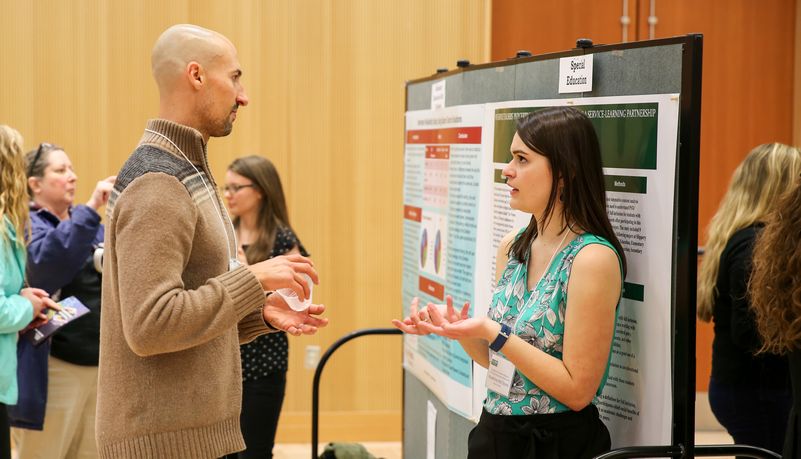 People conversing at the symposium