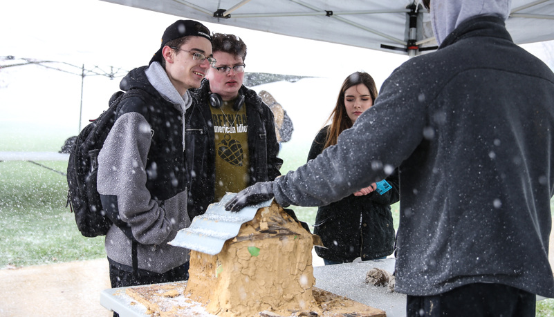 Students learning about alternative housing