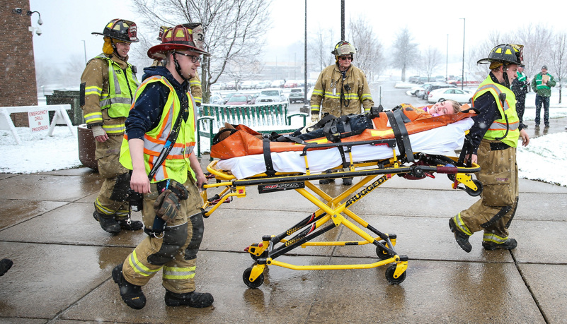 Firemen evacuate the injured