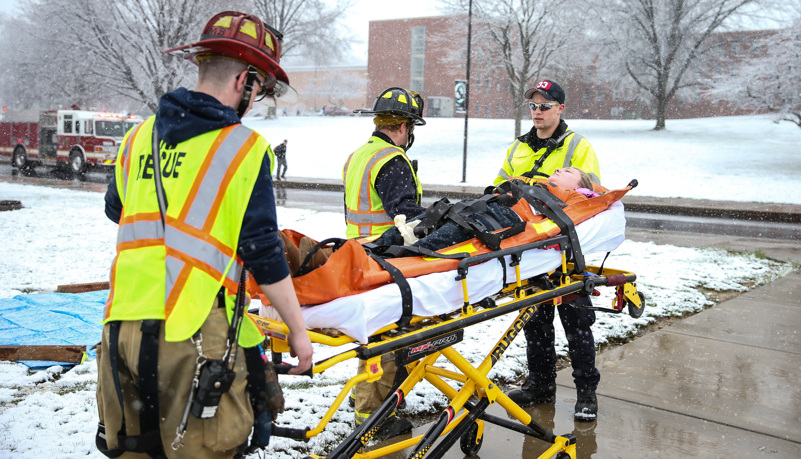 Firemen evacuate the injured