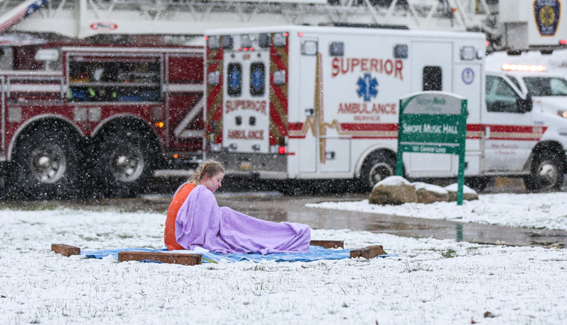 A simulated injured woman waits