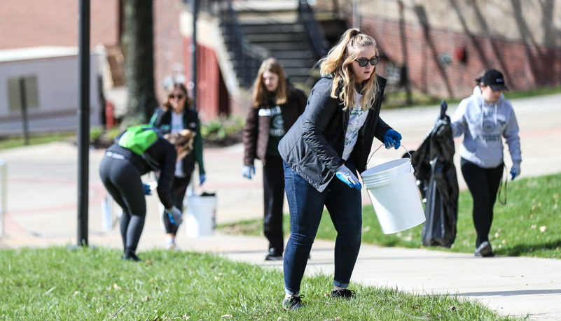 Woman picking up trash