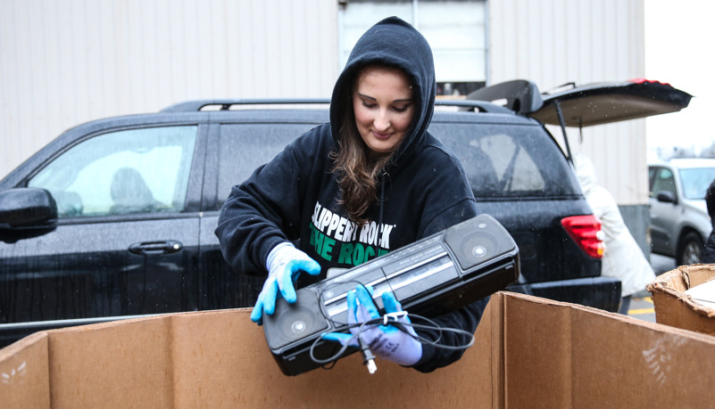 Woman recycling an old radio 