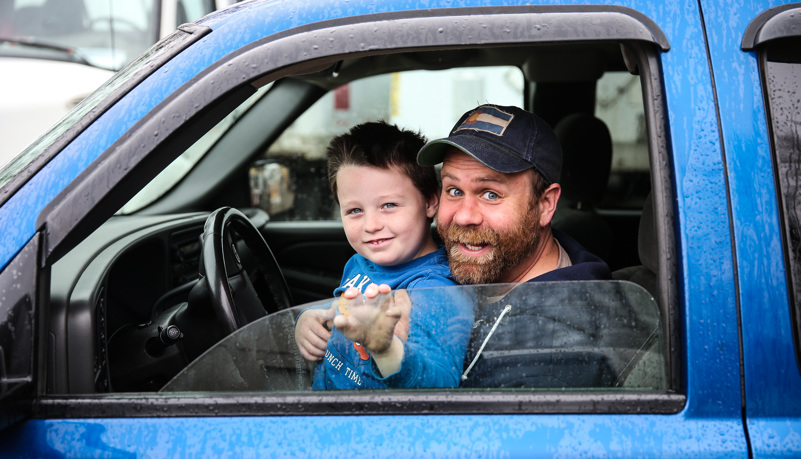 Boy and his father unloading