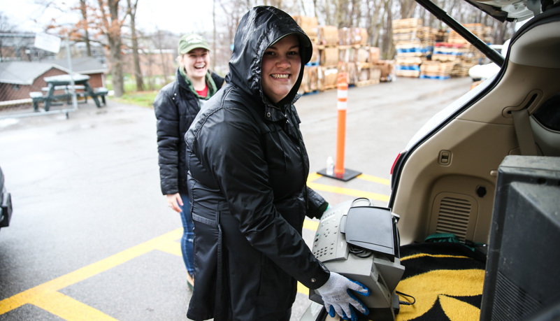 Woman Unloading old electronics