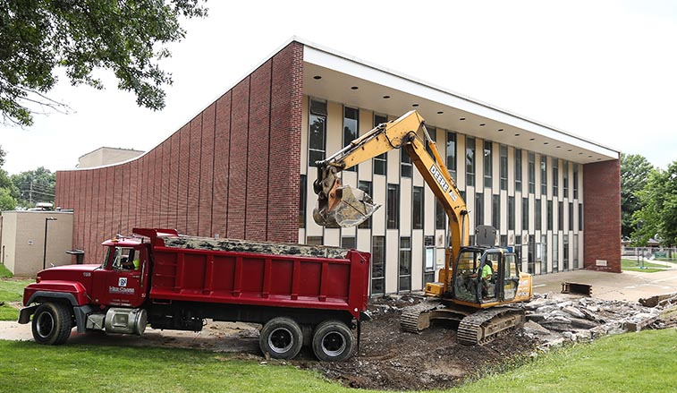 Construction equipment digging up the sidewalk