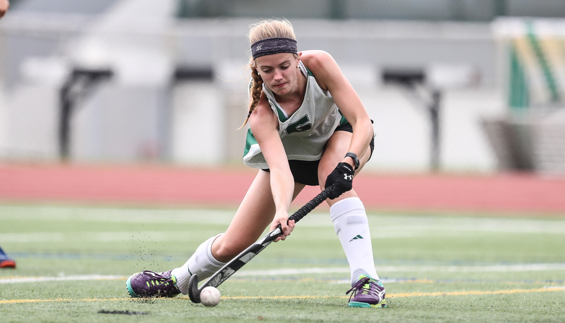 Woman playing field hockey