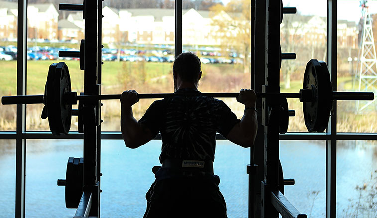 Student lifting weights