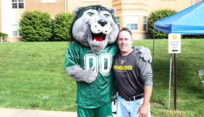 A father posing with Rocky