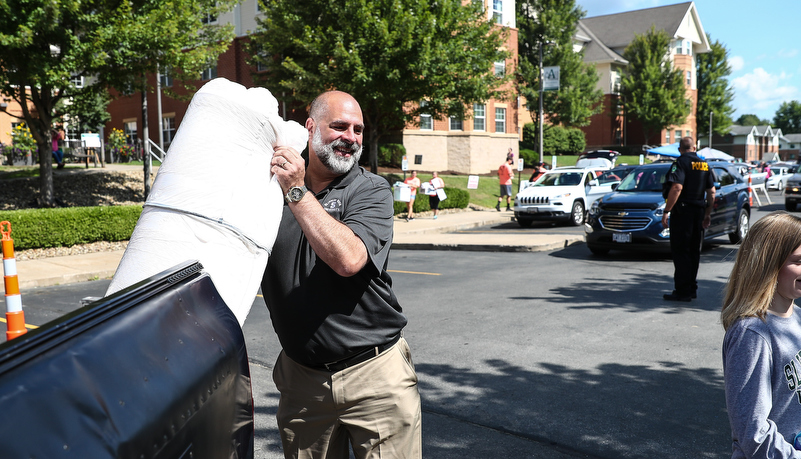 President Behre helps unload