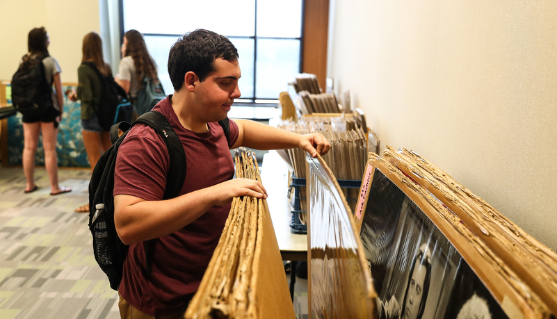 Student looking through posters