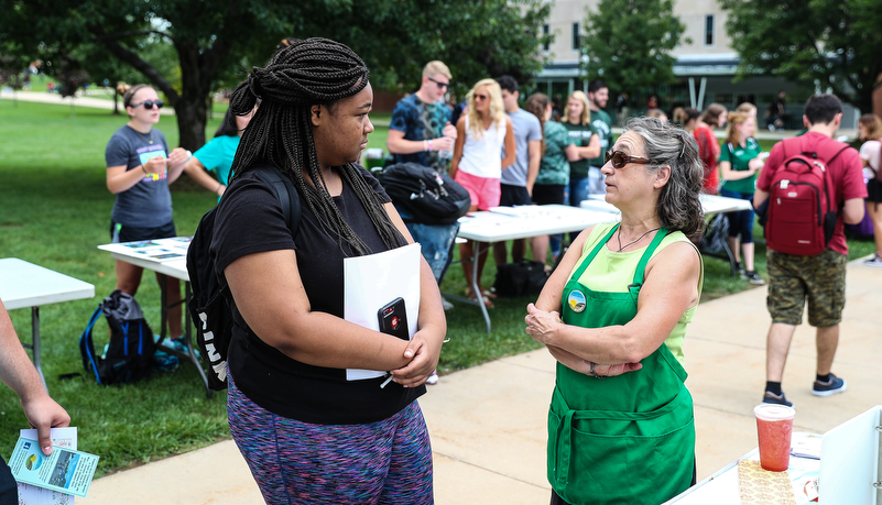 Student talking with a commuity member