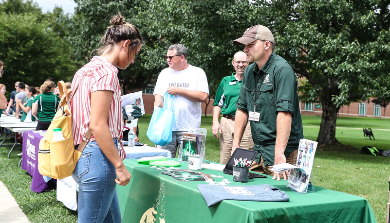 Student talking with a commuity organization member