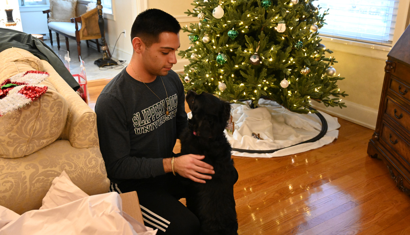 Student playing with the president's dog