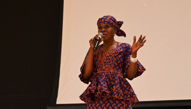 A woman addresses the audience