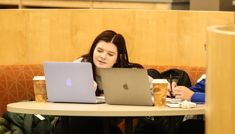 Students studying together on computers