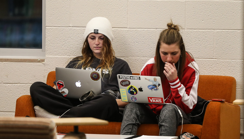 students working together on laptops