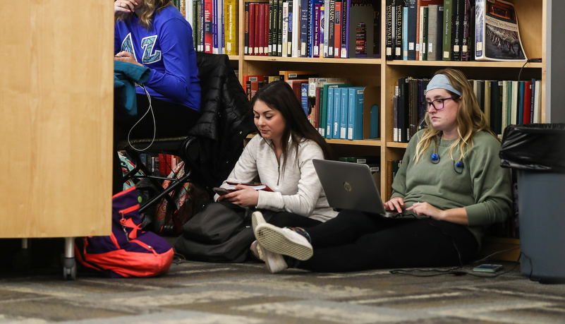 Students sitting on the floor preparing for exams