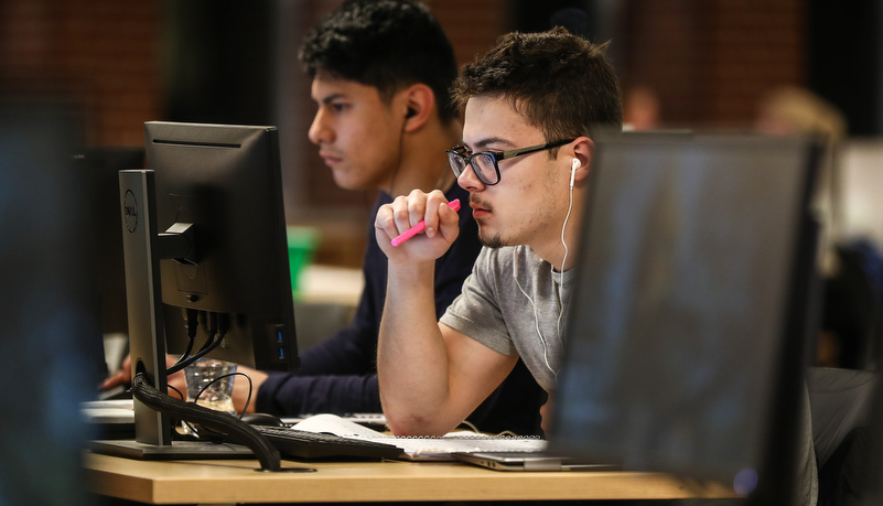 Man reading material on a computer