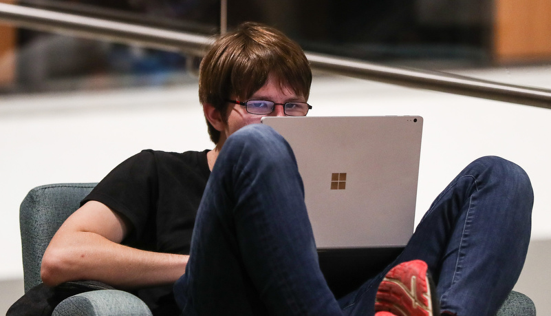 Man reviewing material on a laptop