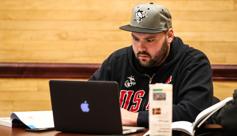 Man reviewing material on a laptop
