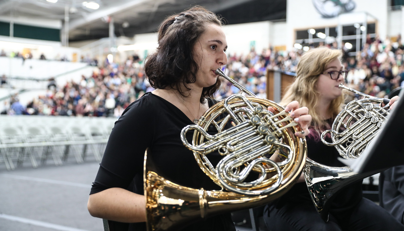 woman plays the french horn