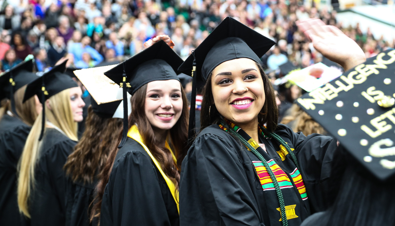 gradutes wait to reciever their diploma