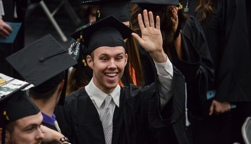 man waves to his family