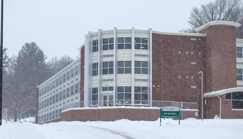 Rhoades Hall through the trees and snow