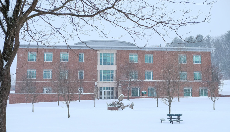 Physical Therapy building through the trees and snow