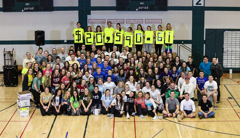 Group photo celebrating the amount of money raised