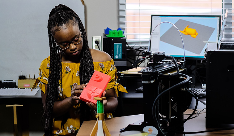 Woman looking at a manufactured part