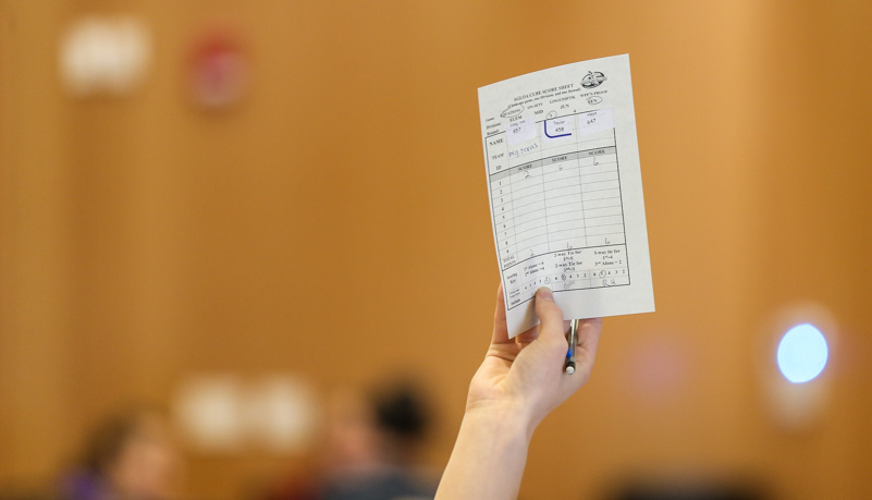 Student holding up a score card
