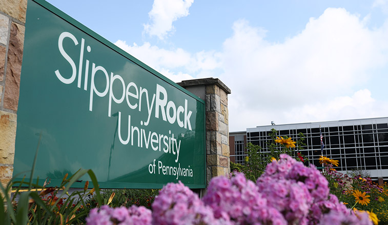 Campus sign and flowers