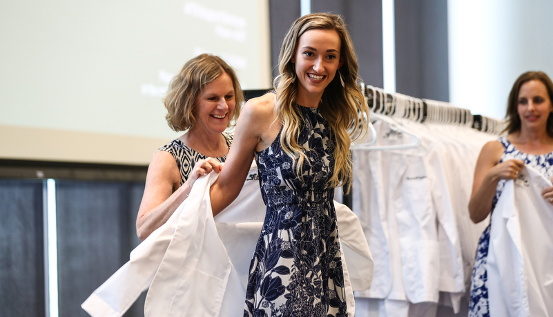 Student receives her white coat