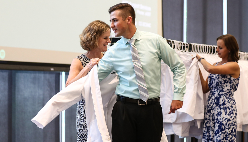 Student receives his white coat