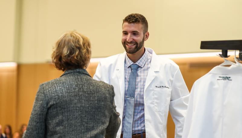 Student receives his white coat