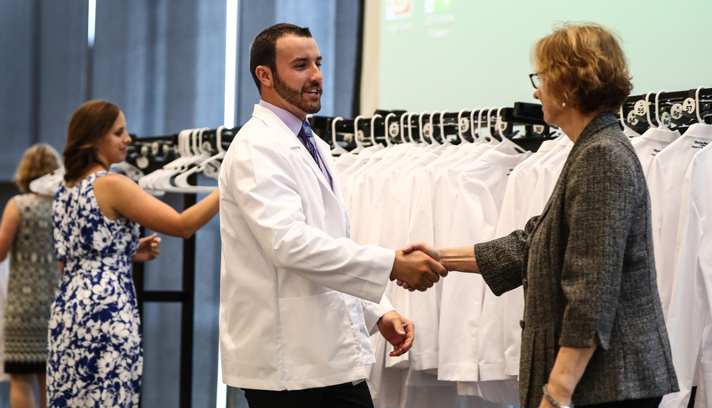 Student receives his white coat