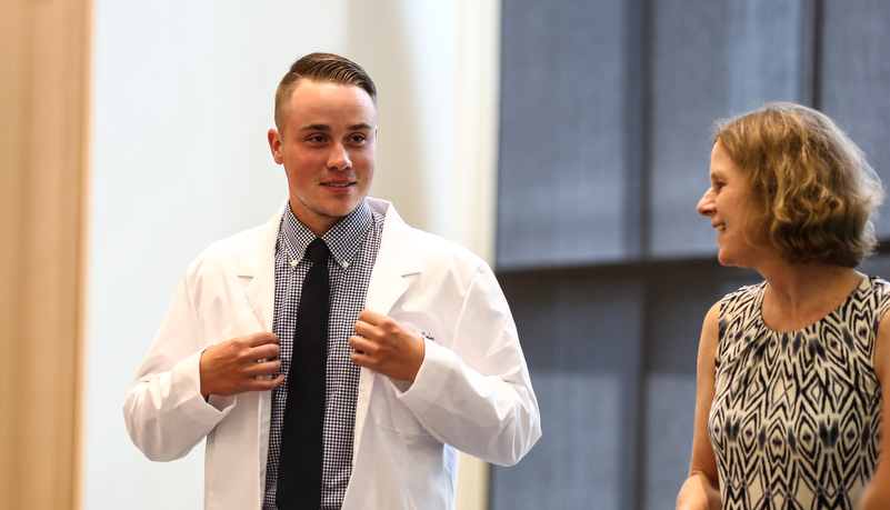 Student recieves his white coat