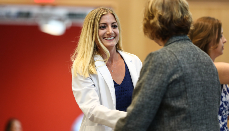 Student receives her white coat