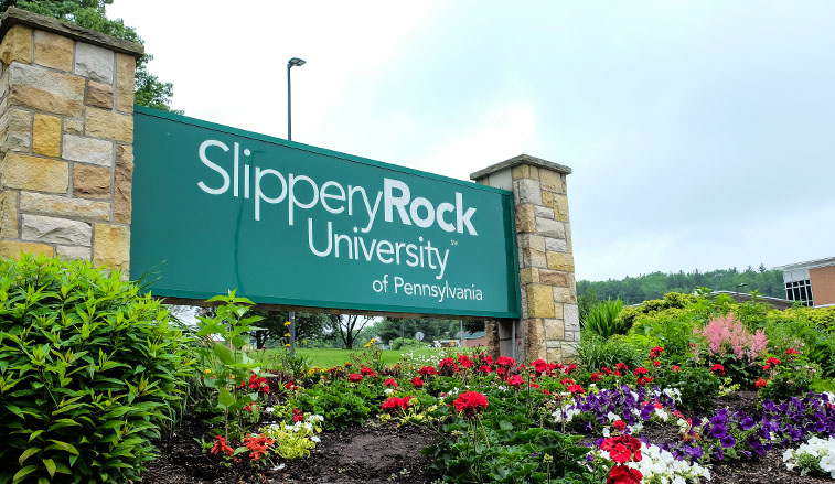 Campus sign and flowers