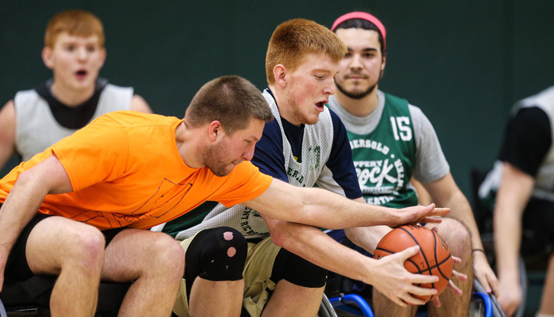 Men battle for a basketball